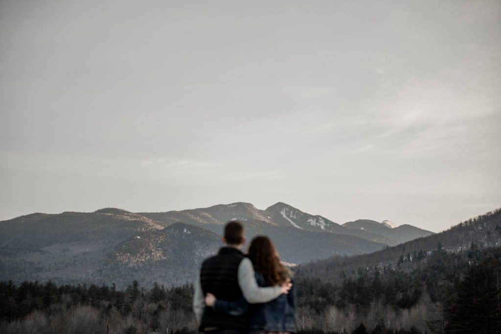 Engagement photos in a field in the Adirondacks