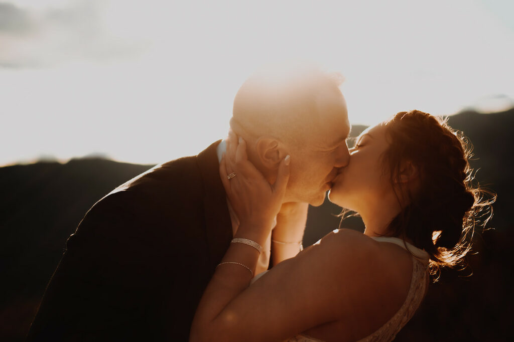 Warm spring kiss between bride and groom 