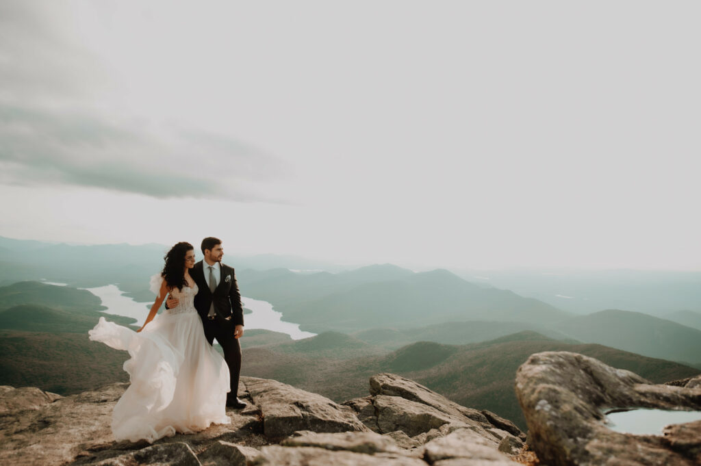 Couple eloping on Whiteface mountain in New York, knowing that it is not selfish to elope, wind blowing her dress