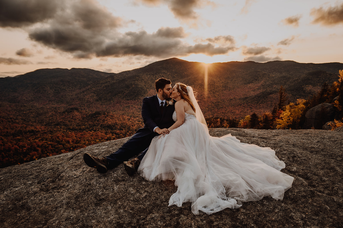 Bride and groom kissing on a mountain in New York 