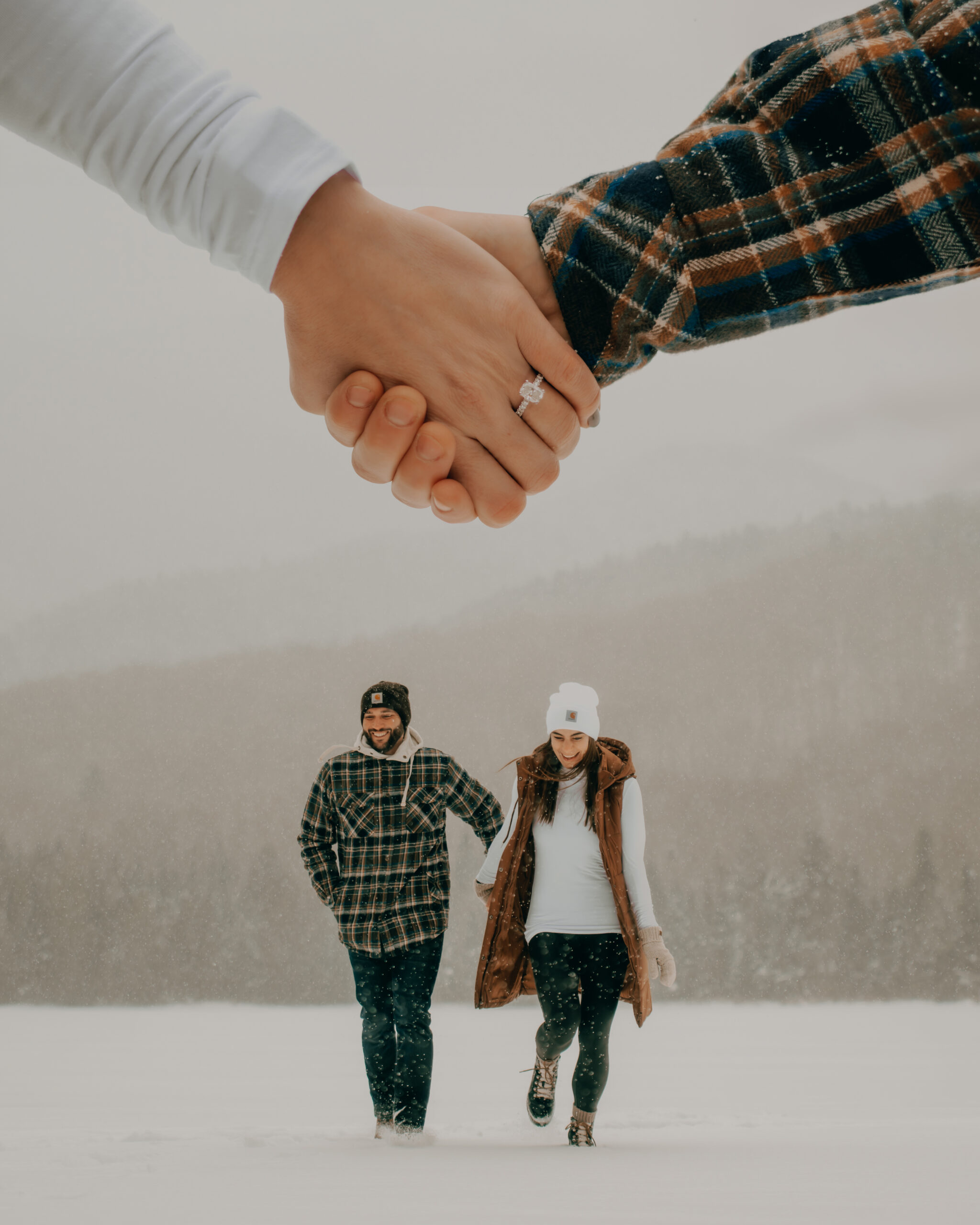 Double exposure showing engagement ring over couple after recent proposal