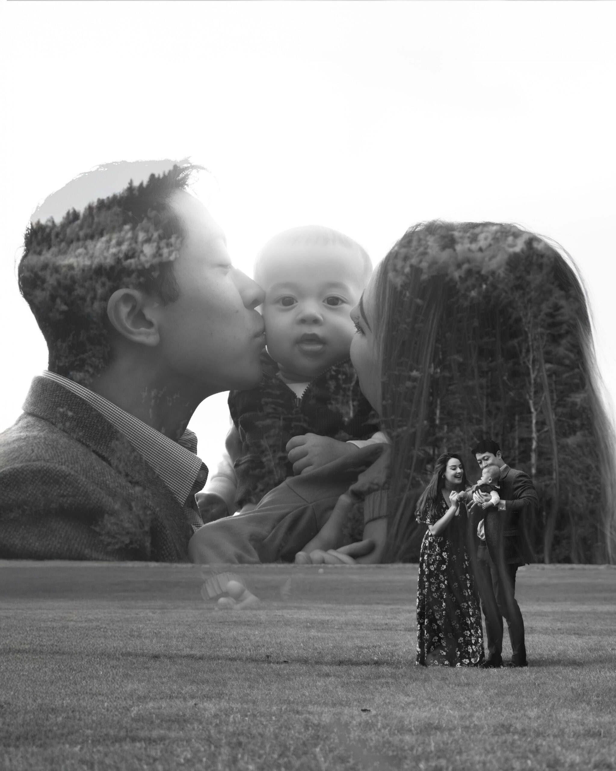 Black and white family photo double exposure with parents kissing their baby's cheeks overlayed on a wide shot of the family